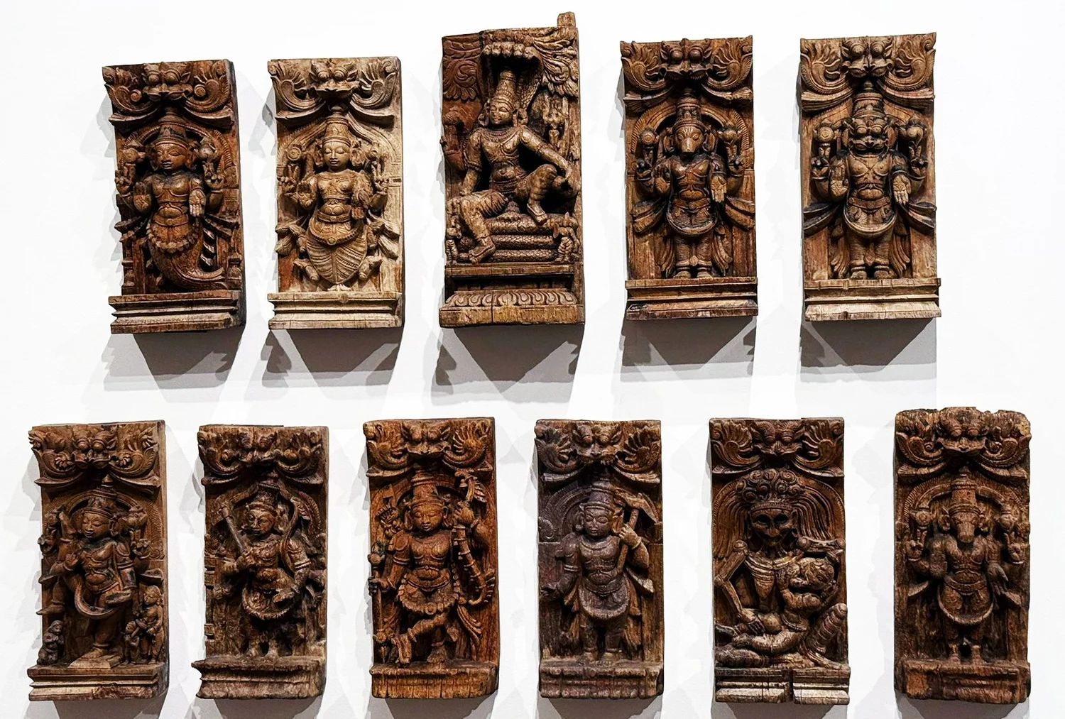 Carved wooden panels showing forms of Vishnu