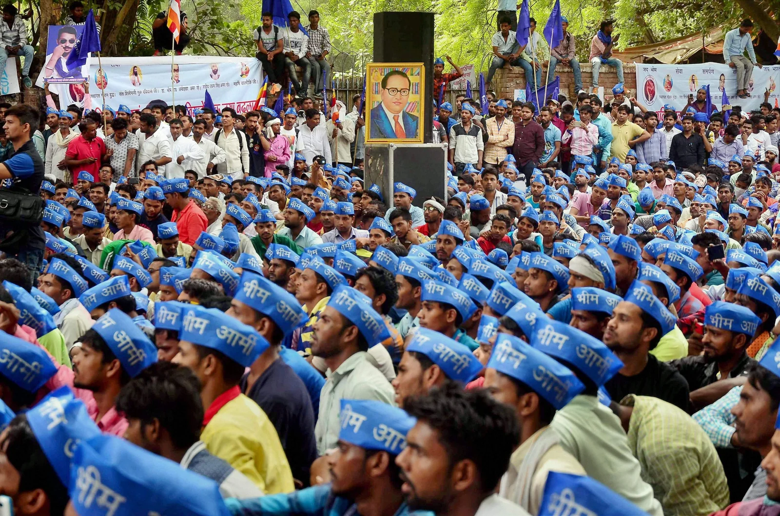 A large gathering of people wearing blue clothing and caps