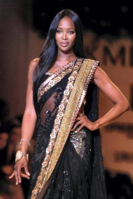 Naomi Campbell walking the runway in a sari