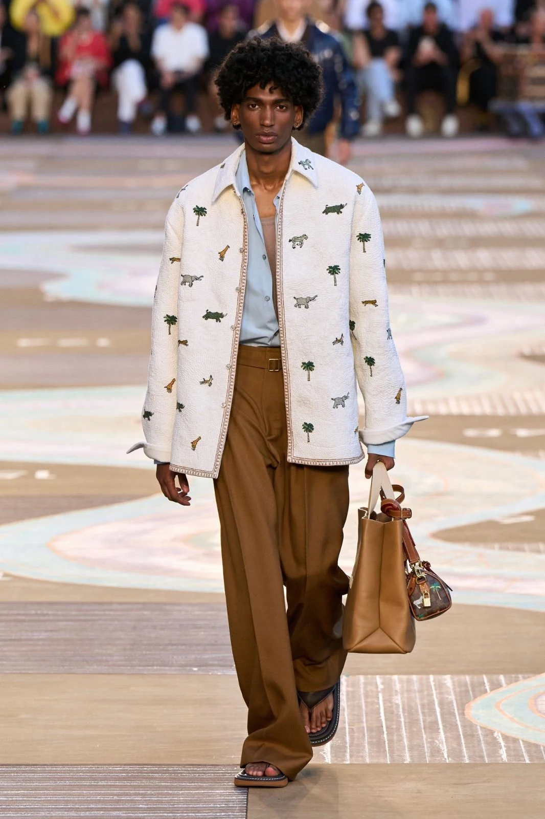 Model wearing an animal motif embroidered jacket on the runway