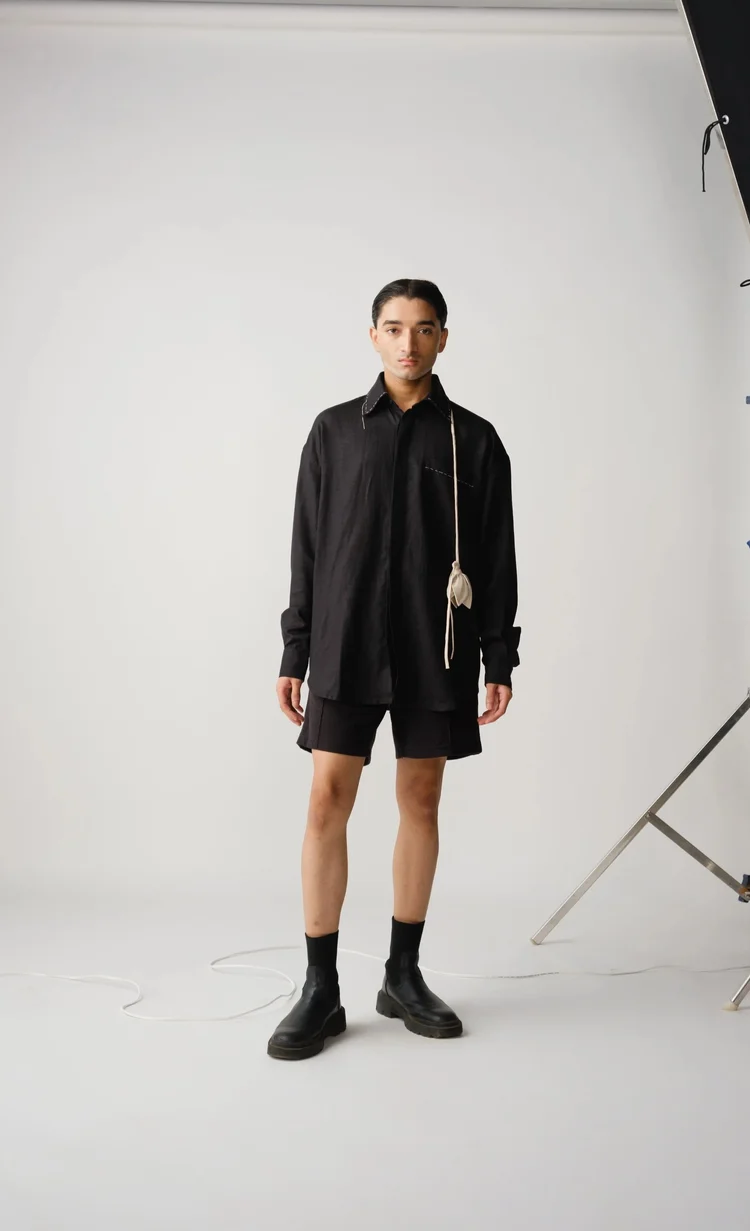 Model in a black shirt and shorts in the studio