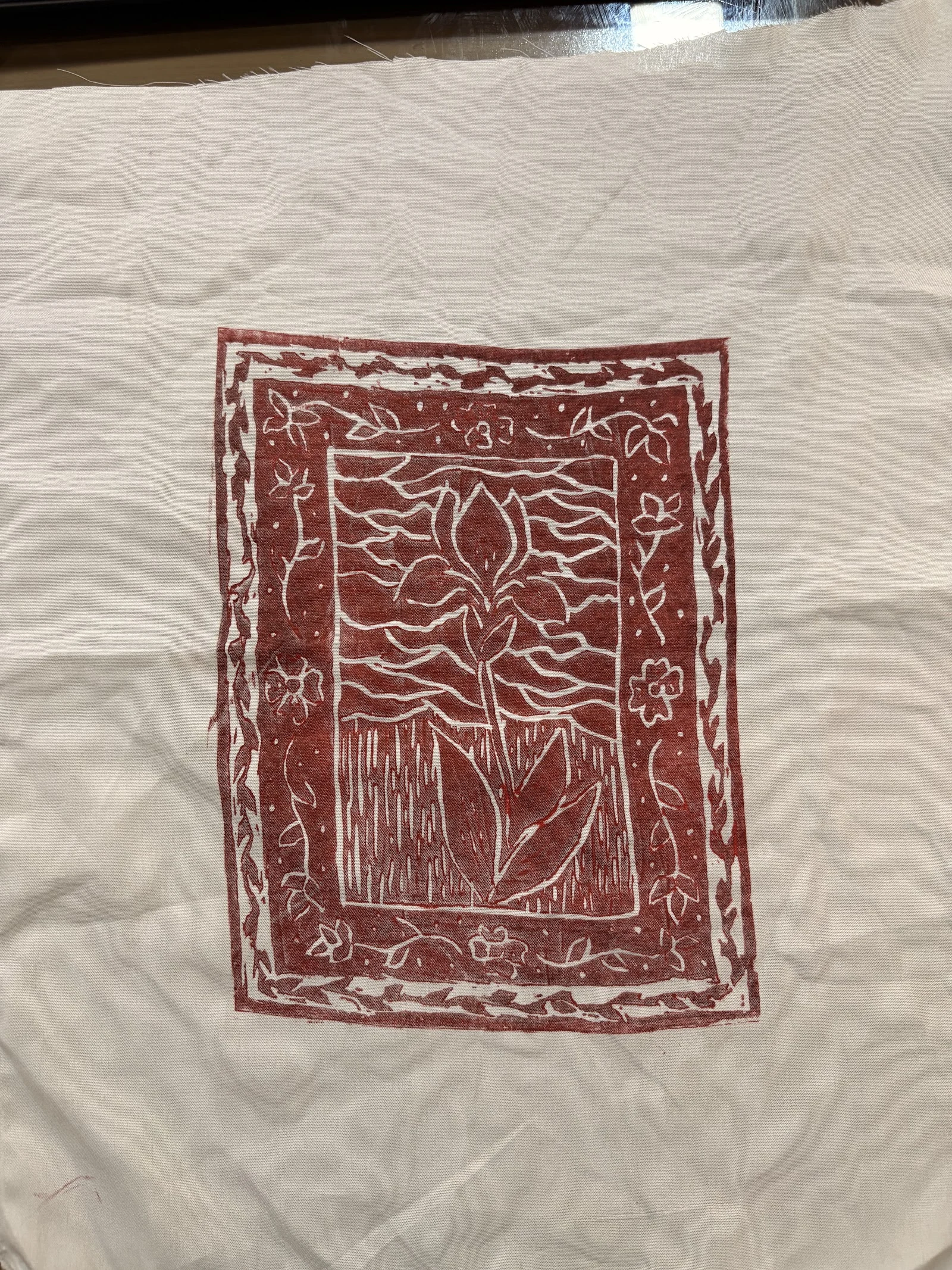 Red floral block print on a cream textile
